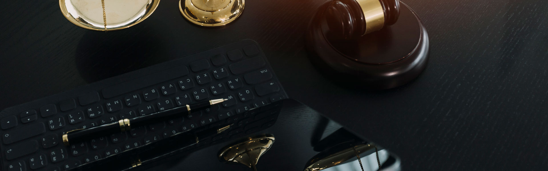 Scales and gavel next to a laptop computer